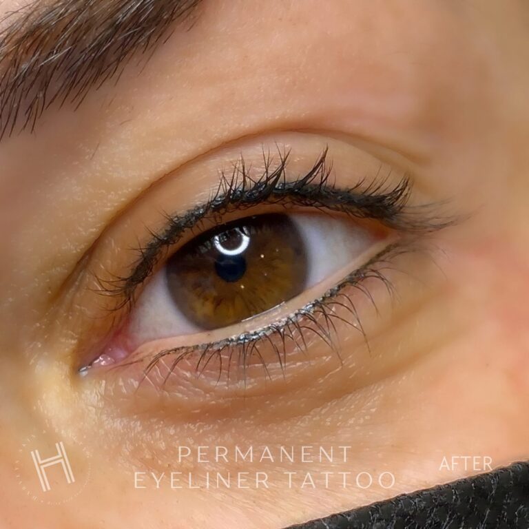 Close-up of brown eye with permanent eyeliner tattoo freshly applied.