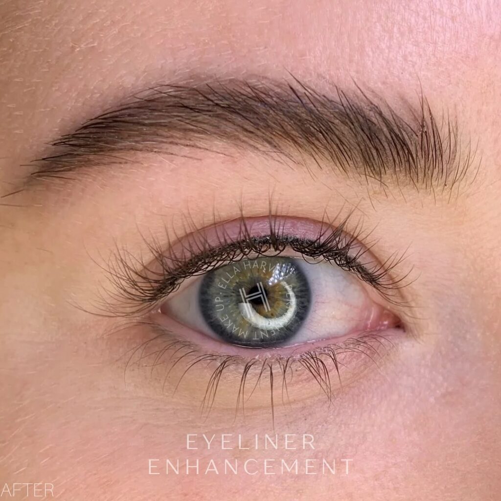 Blue-green eye with freshly applied eyeliner enhancement along lash line.